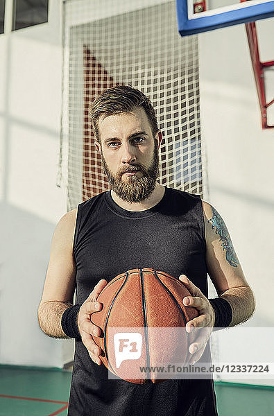 Man holding basketball  indoor