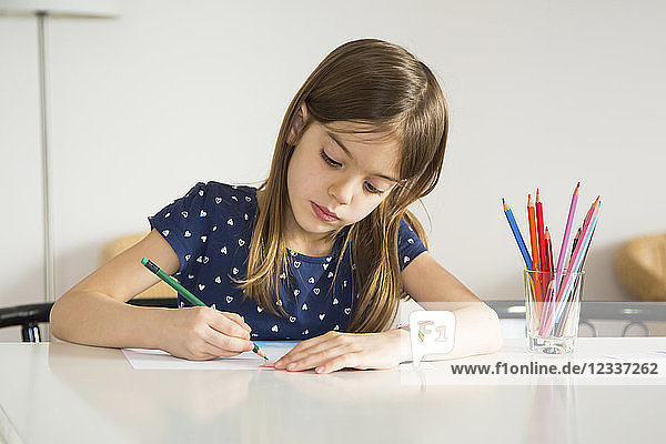 Portrait of little girl drawing