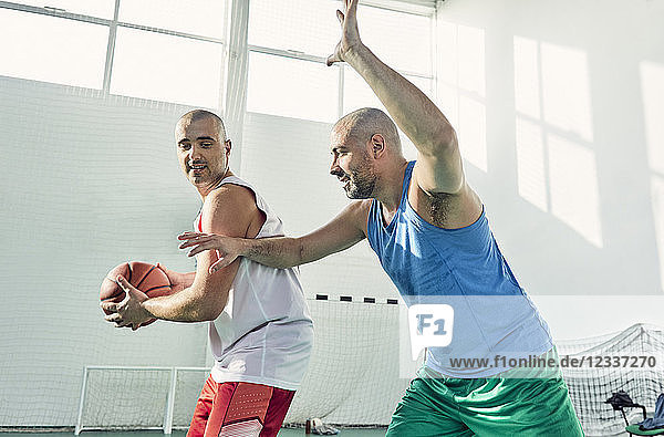 Men playing basketball  defence