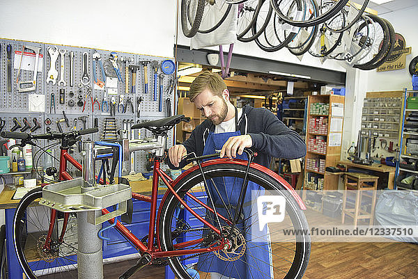 Bicycle mechanic working in his repair shop