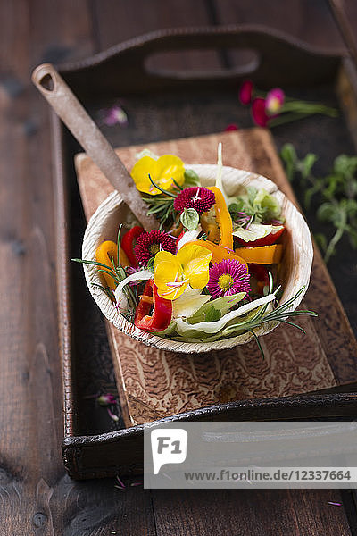 Bowl of mixed salad with herbs and edible flowers