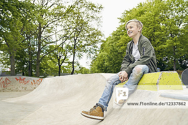 Laughing boy looking to the side in skatepark