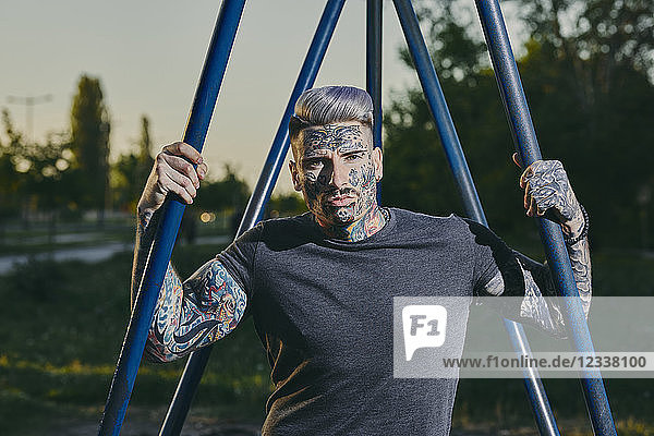 Portrait of tattooed young man outdoors