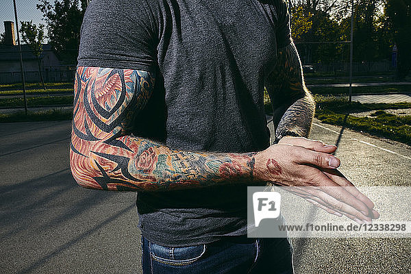 Tattooed arms of a young man outdoors