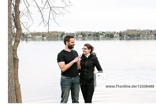 Couple relaxing by lake  Kingston  Canada
