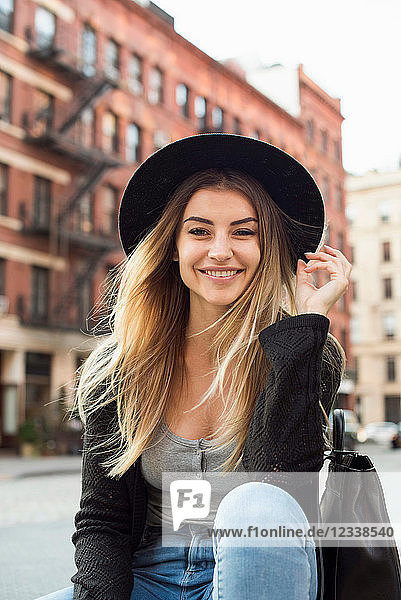 Portrait of woman wearing hat looking at camera smiling  New York  USA