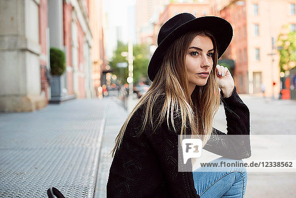 Portrait of woman wearing hat looking away  New York  USA