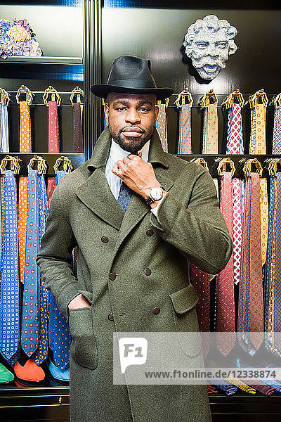Cool male customer wearing trilby in tailors shop  portrait