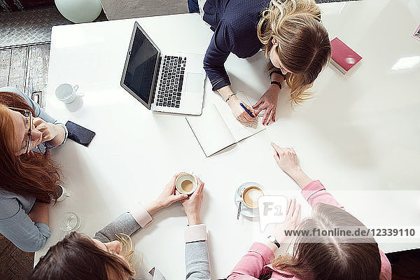 Businesswoman and colleagues having meeting in office