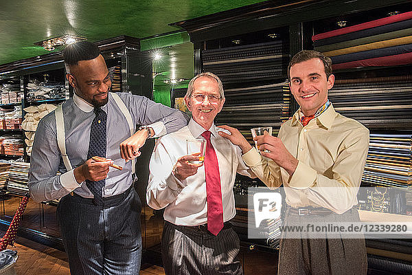 Tailors celebrating in traditional tailors shop  portrait
