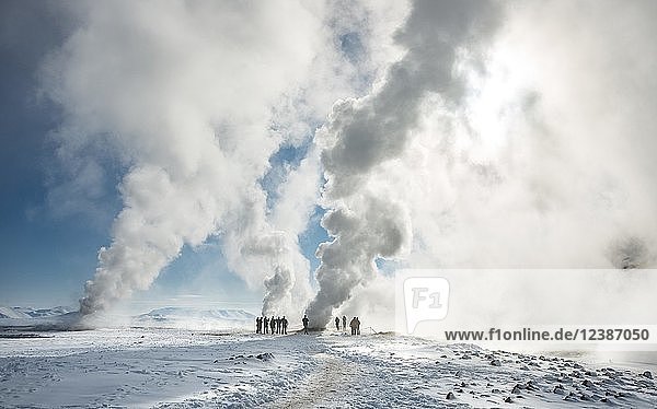 People standing by a fumarole  rising steam  geothermal area Hverarönd  also Hverir or Namaskard  Northern Iceland  Iceland  Europe
