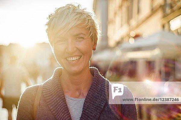 Cheerful woman in the city during summer  portrait  backlight