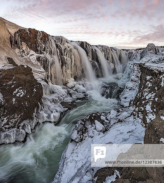 Waterfall with ice and snow in winter Kolugljúfur sunset Norðurland vestra Northern Iceland Iceland Europe