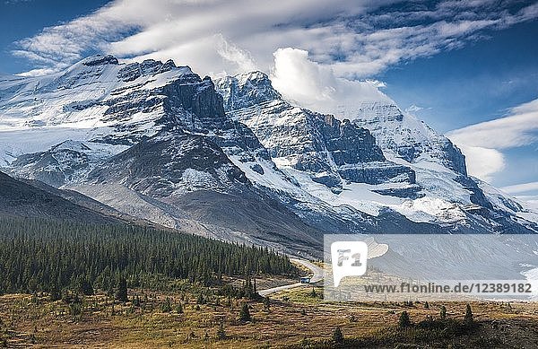 Narrow road with bus in front of spectacular mountain scenery  Mount Athabasca and Mount Andromeda  on Icefield Parkway  Highway 93  Jasper National Park  Rocky Mountains  Alberta  Canada  North America