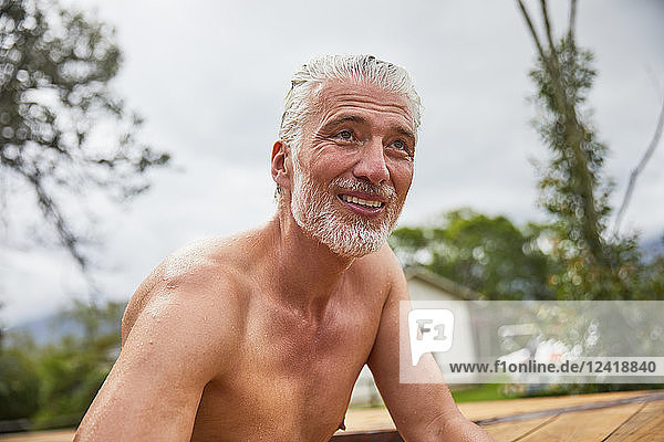 Portrait smiling  confident mature man in hot tub sunny summer deck