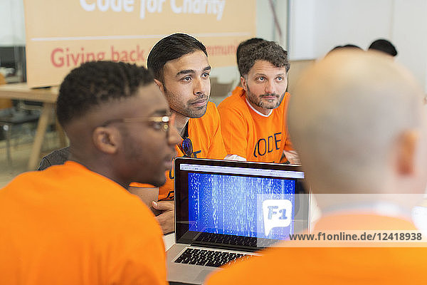 Dedicated hackers coding for charity at hackathon
