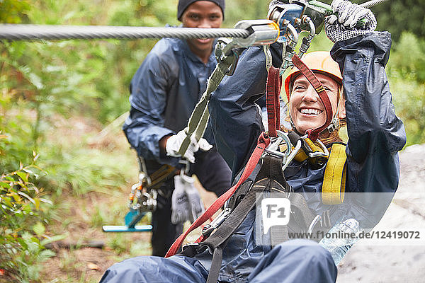 Smiling young woman zip lining