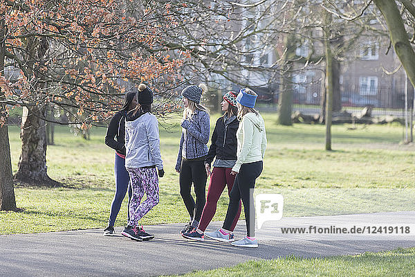 Female runners talking in park