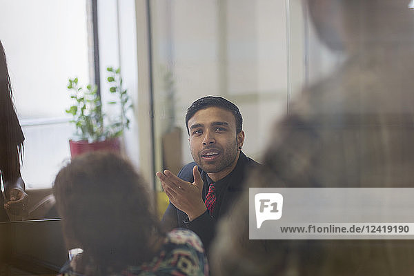 Businessman talking  gesturing in conference room meeting