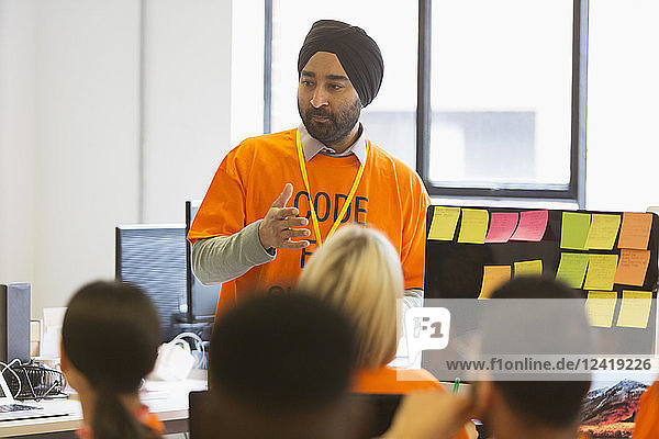 Hacker in turban leading meeting  coding for charity at hackathon