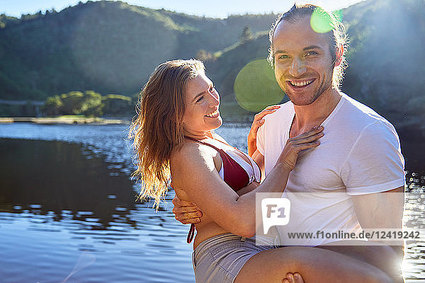 Portrait romantic  carefree couple at sunny summer lake