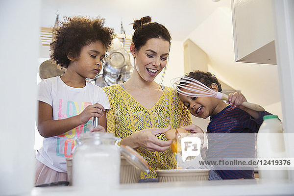 Mother and children baking in kitchen