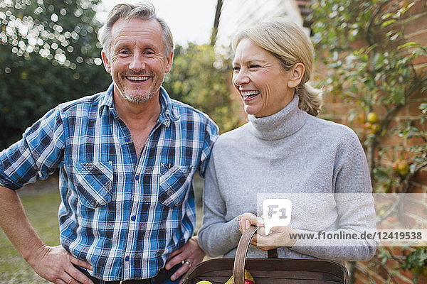Portrait happy carefree mature couple in garden