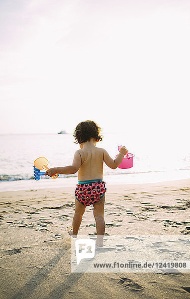 Baby girl playing on the beach