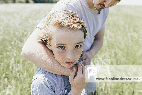 Portrait of boy and young man in a field