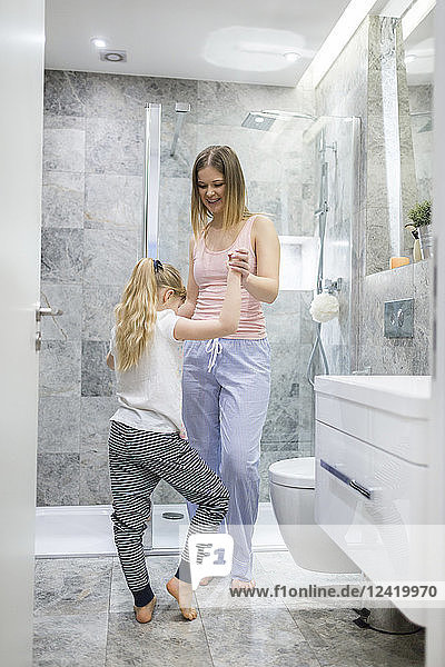 Mother and daughter having fun in the bathroom