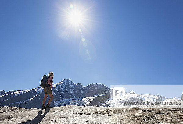 Austria  Carinthia  female hiker watching Grossglockner peak  galcier and high alpine territory  High Tauern National Park