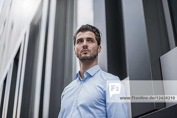 Young businessman in the city outside office building