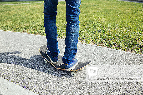 Man standing on broken skateboard