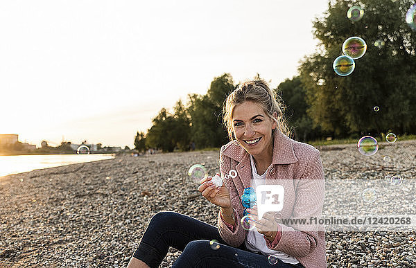Laughing blond woman and soap bubbles