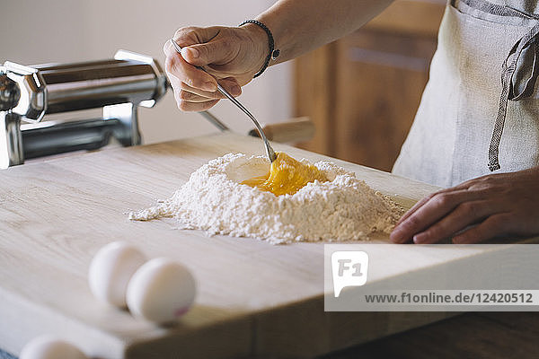Woman preparing pasta dough  flour and eggs