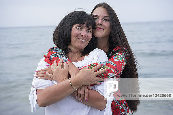 Greece  portrait of happy mother and daughter in front of the sea