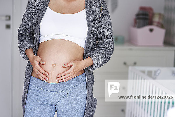 Pregnant woman stroking baby belly