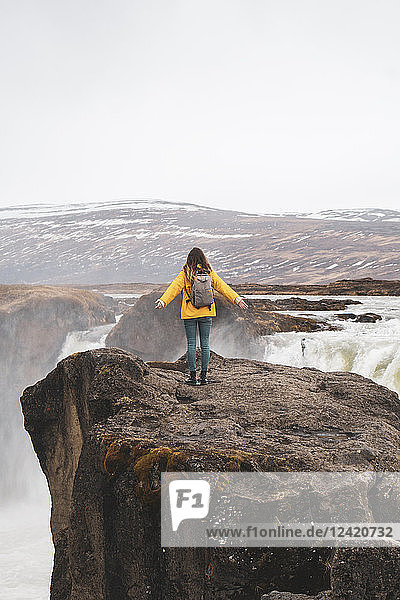 Iceland  woman standing at Godafoss waterfall