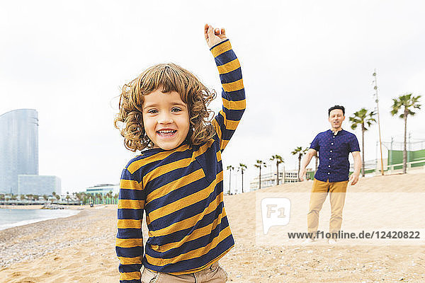 Spain  Barcelona  happy father and son on the beach