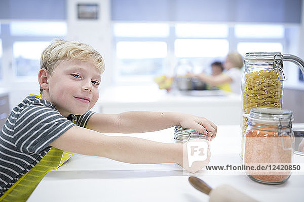 Portrait of smiling schoolboy in cooking class