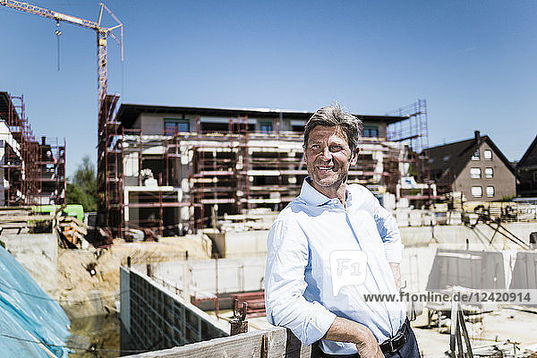 Smiling man on construction site looking around