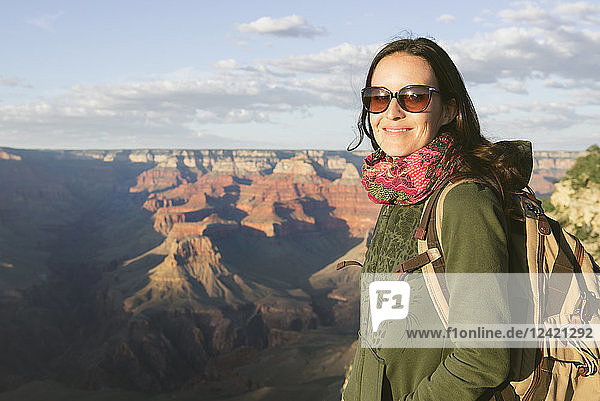USA  Arizona  Grand Canyon National Park  Young woman with backpack exploring and enjoying the landscape