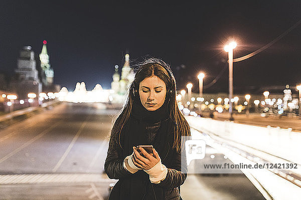 Russia  Moscow  beautiful woman listening music in the city at night