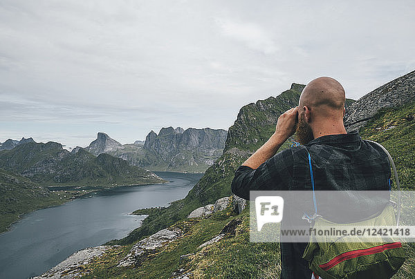 Norway  Lofoten  Moskenesoy  Man looking over Kjerkefjord