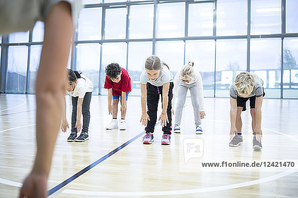 Pupils exercising in gym class