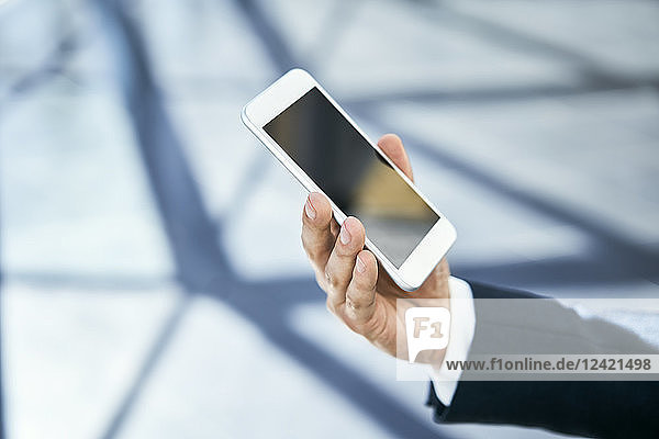 Close-up of businessman holding cell phone