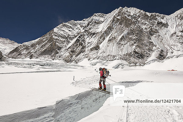 Nepal  Solo Khumbu  Everest  Sagamartha National Park  Mountaineer crossing icefall on a ladder