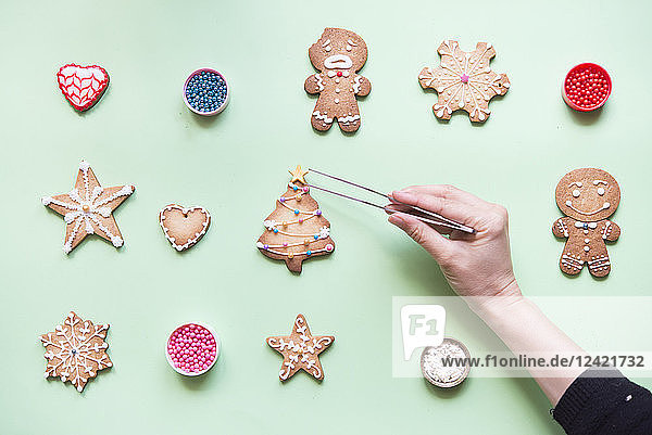 Woman's hand decorating Gingerbread cookies