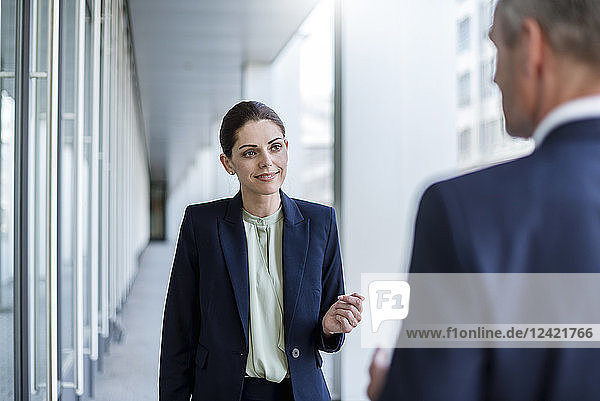 Portrait of smiling businesswoman listening to business partner