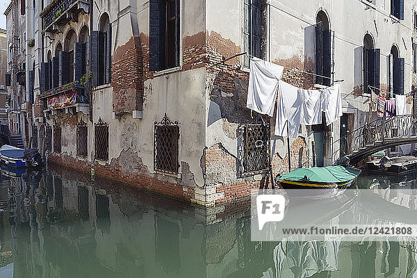 Italy  Venice  boat on canal and laundry at house